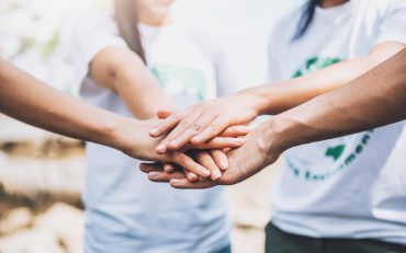 close-up-people-volunteer-teamwork-putting-finger-star-shapehands-togetherstack-handsunity-teamwork-world-environment-day