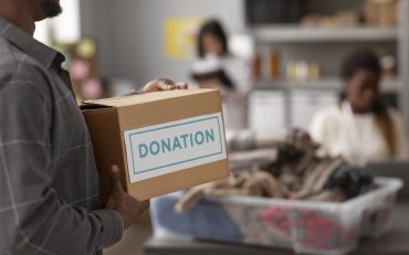 volunteer-helping-with-donation-box